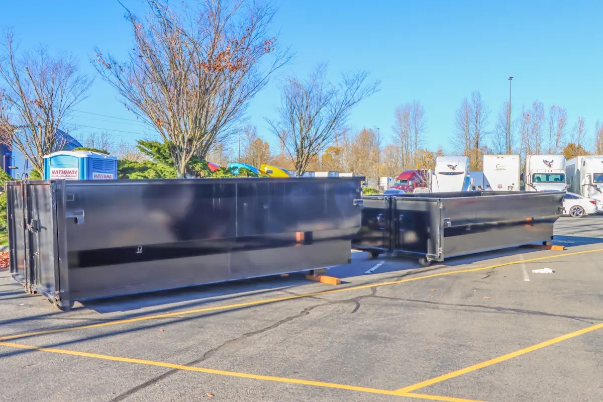 Professional dumpster rental service with roll-off container on residential driveway in Valley City